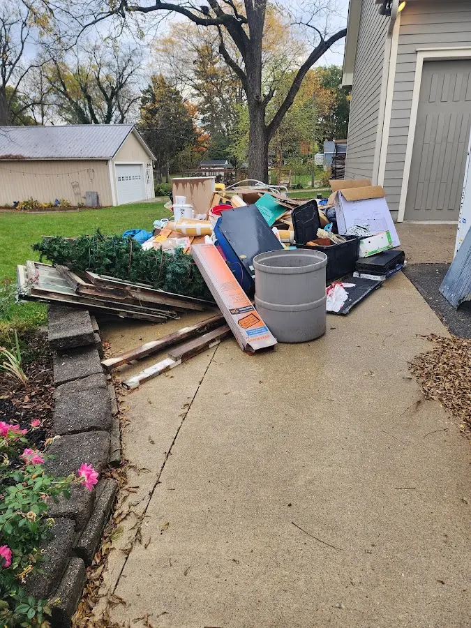 Dumpster being loaded with debris for Estate Cleanout Dumpster Rental in Le Sueur